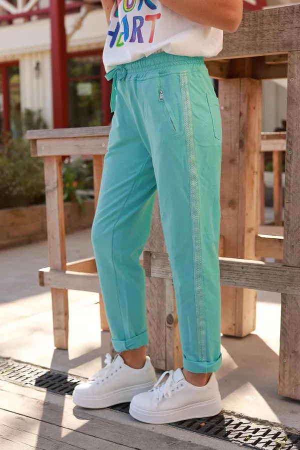 Turquoise cotton jogging bottoms with embroidered cheveron outseams